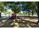 Community playground area with mature shade trees at 22304 Stillwood Dr, Land O Lakes, FL 34639
