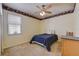 Comfortable bedroom with a ceiling fan, natural light, and a vintage border at 2300 Hannah S Way, Dunedin, FL 34698