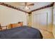 Cozy bedroom with a ceiling fan, natural light, closet, and vintage border at 2300 Hannah S Way, Dunedin, FL 34698