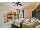 Bedroom with built-in desk and shelving, large window, and ceiling fan at 2300 Hannah S Way, Dunedin, FL 34698