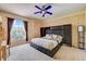 Bedroom with a ceiling fan, built-in storage, and a large window with natural light at 2300 Hannah S Way, Dunedin, FL 34698