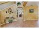 Elegant foyer with a staircase, decorative archway, and stylish tile flooring at 2300 Hannah S Way, Dunedin, FL 34698