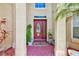 Inviting front entrance with a red brick porch, decorative door, and charming home decor at 2300 Hannah S Way, Dunedin, FL 34698