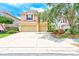 Inviting two-story home with a three-car garage, red shutters, and a well-manicured lawn at 2300 Hannah S Way, Dunedin, FL 34698