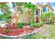 Desirable two-story home with a three car garage and mature tropical landscaping at 2300 Hannah S Way, Dunedin, FL 34698