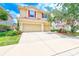 Inviting two-story home with a three-car garage, red shutters, and a well-manicured lawn at 2300 Hannah S Way, Dunedin, FL 34698