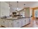 Bright kitchen boasts granite countertops, stainless appliances, and pendant lighting at 2300 Hannah S Way, Dunedin, FL 34698