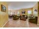Comfortable living room with plush green sofas and traditional decor and lots of natural light at 2300 Hannah S Way, Dunedin, FL 34698