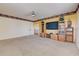 Living room featuring neutral carpet, ceiling fan, and built in shelving at 2300 Hannah S Way, Dunedin, FL 34698