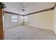Neutral carpeted living room with large windows and natural light at 2300 Hannah S Way, Dunedin, FL 34698