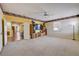 Bright living room with carpet, ceiling fan, and large TV at 2300 Hannah S Way, Dunedin, FL 34698