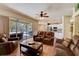 Open-concept living room showcasing easy access to the kitchen and the outdoor pool area at 2300 Hannah S Way, Dunedin, FL 34698