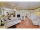 Main bedroom with wood floors, ceiling fan, and en suite bathroom at 2300 Hannah S Way, Dunedin, FL 34698