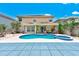Gorgeous backyard featuring a pool with spa, covered patio, and lush tropical landscaping at 2300 Hannah S Way, Dunedin, FL 34698