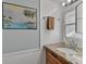 Bathroom featuring granite countertop and tiled walls at 2331 Belleair Rd # 214, Clearwater, FL 33764