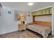 Bedroom with hardwood floors, artwork, and a murphy bed at 2331 Belleair Rd # 214, Clearwater, FL 33764