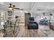 Open-concept space with a modern dining set, wood floors, and access to the living room at 2331 Belleair Rd # 214, Clearwater, FL 33764