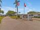 Welcoming community entrance with flags, signage, and well-kept landscaping at 2331 Belleair Rd # 214, Clearwater, FL 33764