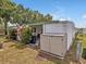 Well-maintained exterior with storage shed, landscaping, and a cozy outdoor dining area at 2331 Belleair Rd # 214, Clearwater, FL 33764