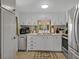 Bright kitchen with white cabinets, stainless steel appliances, and lots of counter space at 2331 Belleair Rd # 214, Clearwater, FL 33764