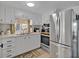 Well-lit kitchen featuring modern appliances, white cabinetry, and a functional layout at 2331 Belleair Rd # 214, Clearwater, FL 33764