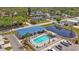 Aerial view of a community pool, surrounded by lush landscaping and comfortable seating at 2331 Belleair Rd # 214, Clearwater, FL 33764