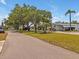 Charming street view featuring mature trees, lush lawns, and inviting homes at 2331 Belleair Rd # 214, Clearwater, FL 33764