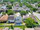 An aerial view showcasing a neighborhood with mature trees, homes, and a community pool at 2510 Cross More St, Valrico, FL 33594