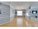 Elegant dining area with hardwood floors, wainscoting, and a modern chandelier at 2510 Cross More St, Valrico, FL 33594