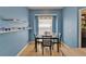 Bright dining room features hardwood floors, natural light, and light-blue accent wall at 2510 Cross More St, Valrico, FL 33594