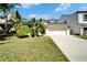 Charming single-Gathering home with a well-manicured lawn, lush tropical landscaping and a two-car garage at 2510 Cross More St, Valrico, FL 33594