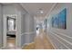 Long hallway with hardwood floors and decorative trim, leading to bedrooms and living spaces at 2510 Cross More St, Valrico, FL 33594
