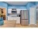Contemporary kitchen featuring blue walls, white cabinets, stainless steel appliances, and an island at 2510 Cross More St, Valrico, FL 33594