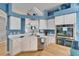 Stylish kitchen showcasing blue walls, white countertops, stainless steel appliances, and a functional island at 2510 Cross More St, Valrico, FL 33594