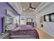 This main bedroom features tray ceiling, fan, and en suite bath at 2510 Cross More St, Valrico, FL 33594