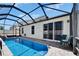 Screened-in pool with brick patio and sliding glass doors to the house at 2510 Cross More St, Valrico, FL 33594