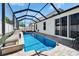 Screened-in pool area featuring a waterfall feature, lounge chairs, and outdoor living space at 2510 Cross More St, Valrico, FL 33594