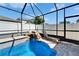 A refreshing pool with a waterfall feature and a lounge chair for relaxation at 2510 Cross More St, Valrico, FL 33594