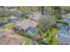Aerial view of a home highlighting the backyard pool, playground, mature trees, and privacy fence at 2706 Bent Leaf Dr, Valrico, FL 33594