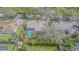 An aerial view highlights the backyard pool, playground, mature trees, and well-maintained lawn at 2706 Bent Leaf Dr, Valrico, FL 33594