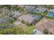 An aerial view showcases the property with its well-manicured lawn, pool, and mature trees in a suburban setting at 2706 Bent Leaf Dr, Valrico, FL 33594