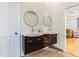 Bathroom featuring dual vanities, stylish mirrors, and access to an adjacent bedroom at 2706 Bent Leaf Dr, Valrico, FL 33594
