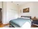 Bright bedroom with hardwood floors, closet, modern light fixture and decorative world map at 2706 Bent Leaf Dr, Valrico, FL 33594