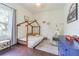 Bright bedroom with hardwood floors, teepee, window, and modern decor at 2706 Bent Leaf Dr, Valrico, FL 33594