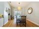 Dining area with hardwood floors, a modern light fixture, and sliding glass doors leading to the backyard at 2706 Bent Leaf Dr, Valrico, FL 33594