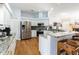 Modern kitchen with white cabinets, granite countertops, stainless steel appliances, and hardwood floors at 2706 Bent Leaf Dr, Valrico, FL 33594