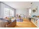 Open-concept living area featuring hardwood floors, neutral walls, and a large window at 2706 Bent Leaf Dr, Valrico, FL 33594