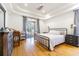 Spacious main bedroom with tray ceiling and sliding glass doors to outdoor pool area at 2706 Bent Leaf Dr, Valrico, FL 33594