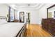 Bright and airy main bedroom with tray ceiling, hardwood floors, and access to ensuite bathroom at 2706 Bent Leaf Dr, Valrico, FL 33594
