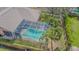 Aerial view of a private screened-in pool surrounded by lush landscaping and a well-maintained yard at 2706 Bent Leaf Dr, Valrico, FL 33594